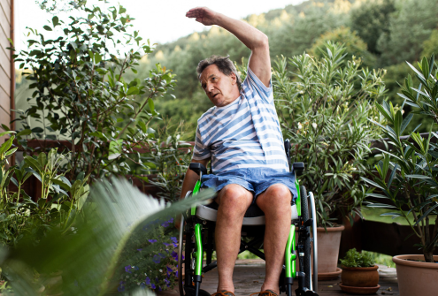 Man in a wheelchair stretching